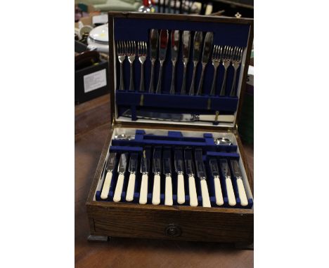 A VINTAGE OAK CASED CANTEEN OF CUTLERY (UNCHECKED)