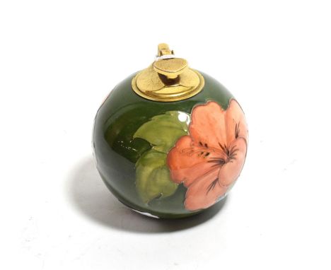 A 1950's Walter Moorcroft pottery table lighter in the Hibiscus pattern on a green ground, 11cm high 