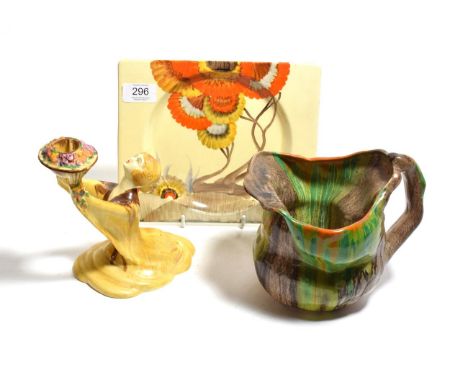 A Clarice Cliff Bizarre candlestick, a Bizarre rectangular plate, Clarice Cliff Le Bon Dieu jug (3) 