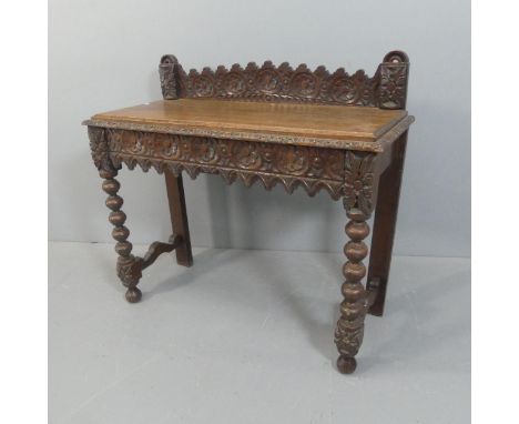 A 19th century gothic style hall table, with raised back, single drawer, carved decoration and bobbin turned supports. Width 