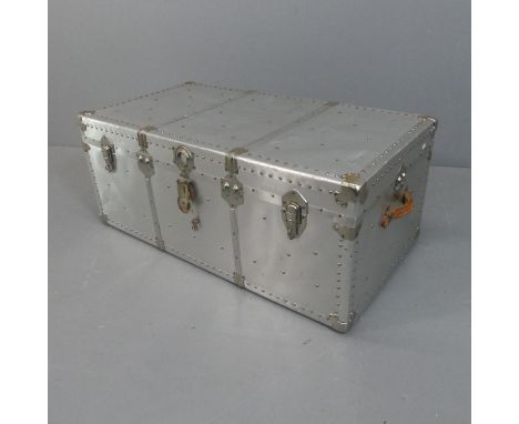 An aviator style trunk, covered with rivited aluminium sheets. Width 107cm, height 43cm, depth 57cm.Good used condition, with