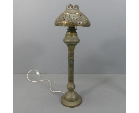 A 19th century Middle-Eastern Moorish pierced and chased brass floor lamp, converted from an oil lamp. Height 108cm.appears i
