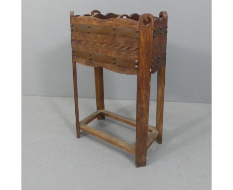 An early 20th century oak Arts & Crafts style stick / umbrella stand in the manner of Liberty and co.. Width 52cm, height 77c