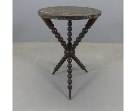An antique gypsy table, with circular oak top on mahogany bobbin-turned tripod base. Diameter 48cm, height 72cm.