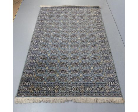 A large vintage teal ground Bokhara carpet. 240x160cm.