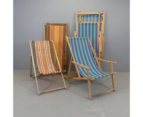 Two sets of three vintage 1970s deck chairs, with fabric sling seats on teak frames.