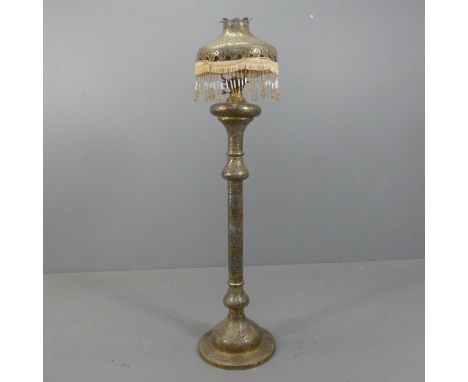 A middle-eastern floor standing oil lamp and shade. Height overall 153cm.