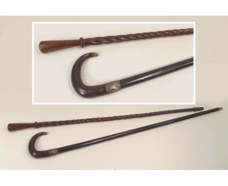 WALKING STICKS.A hardwood walking cane with twist shaft & copper wire ferrule (possibly African) & a silver mounted ebonised 