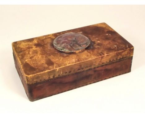 LEATHER BOX.A leather covered playing card box, the lid inset a high fired ceramic, Ruskin-style roundel. 13x12x6cm.