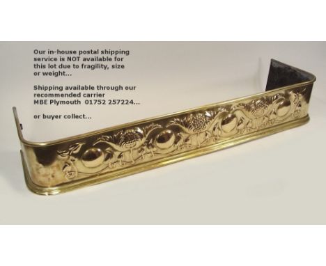 BRASS FENDER. An Art Nouveau brass fender. Width 131cm.