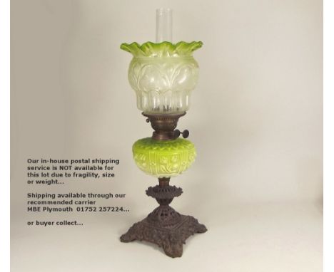 OIL LAMP. A Victorian oil lamp with moulded glass font, etched shade &amp; pierced cast iron base. Height 58cm.