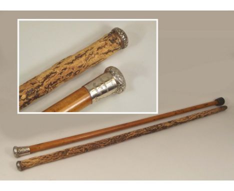 WALKING CANES. A Malacca walking cane with Welsh engraved Porthmadog pommel &amp; a cork walking stick.