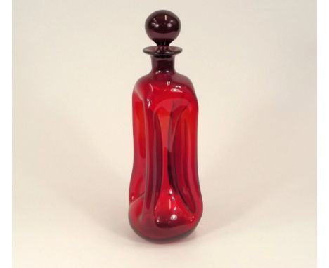 DECANTER. A Victorian ruby glass waisted decanter. Height 30cm.