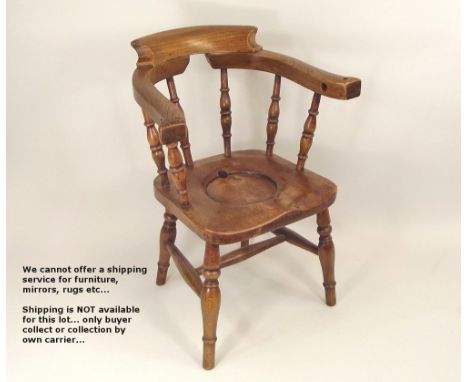 CHILD'S CHAIR. A mid Victorian child's commode chair, in the form of a smoker's bow armchair. Height 57cm.