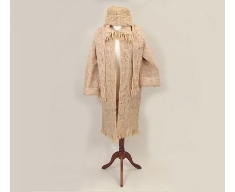KNITTED COAT ETC. A hand knitted coat with fringing &amp; pockets, matching scarf &amp; hat.