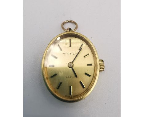 A Tissot 18ct yellow gold automatic ladies pendant watch with hanging loop. Oval face with gilt batons. The inside of the bac