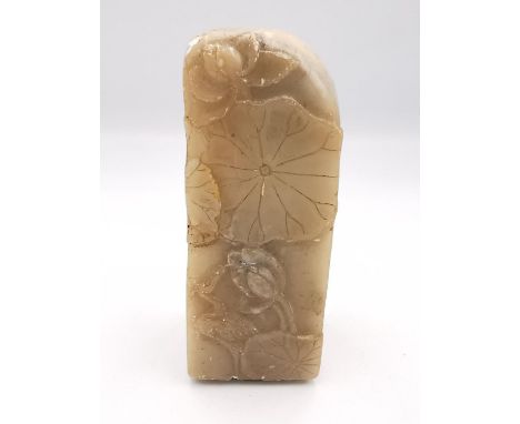 A 19th century carved Chinese soapstone seal with relief lotus leaf, pod and bird decoration. The carved carnelian seal to th