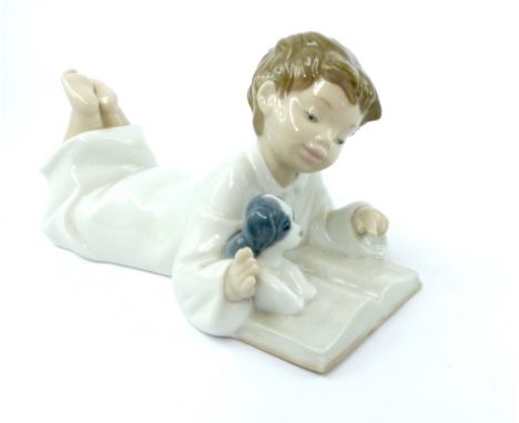Nao porcelain figurine of a boy reading book, 19cm, together with a large Bretby lustre glazed pottery vase, of ovoid form, d