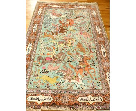 Qum part silk rug, decorated with hunting scene over pale blue ground, within floral and script border,  276x 188cm