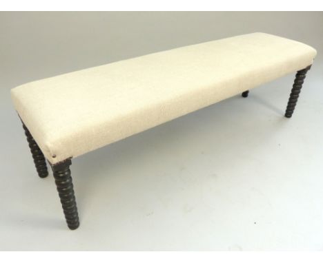 Upholstered window seat, the rectangular seat on ebonised bobbin turned legs, 150cm w