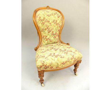 Late 19th century spoonback chair, walnut frame, scroll terminus, bow front seat, turned legs and castors, later red cherry u