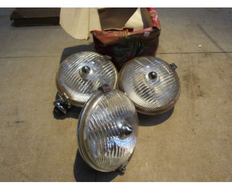 Two chromed Lucas 576 lamps and a boxed WFT576 fog lamp.