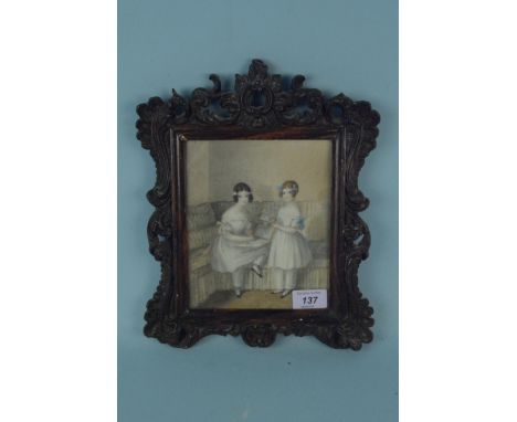 An early 19th Century framed watercolour portrait of two young girls, in a carved moulded frame