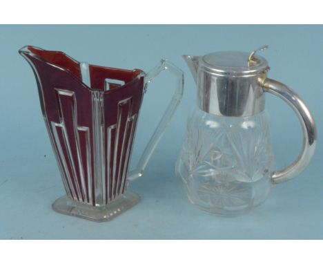 An Art Deco ruby flashed lemonade jug, a cut glass and white metal jug, this with interior glass ice tube (some wear to plate