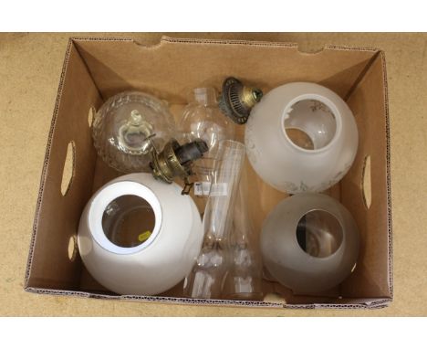 A box of mixed oil lamp parts including burners, funnels and shades
