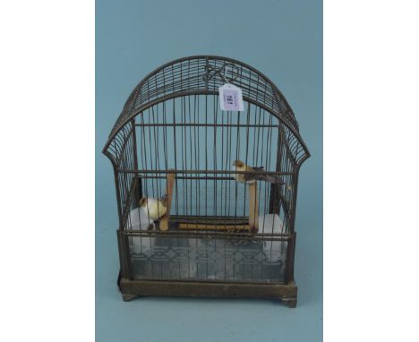 A mid century metal bird cage with ceramic feeders, approx 40cm tall