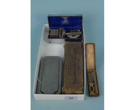 A boxed Wilkinson razor, a 'Bedford' safety razor, a Rolls razor and whetstone