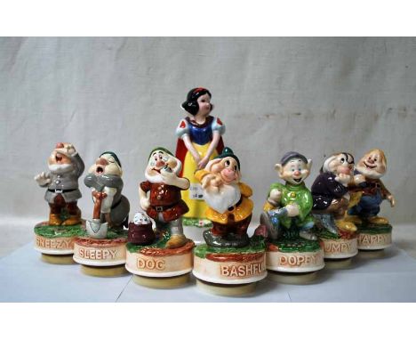 A set of glazed ceramic figures of Snow White and the Seven Dwarves by Schmid, each figure rotates on a musical base, Snow Wh