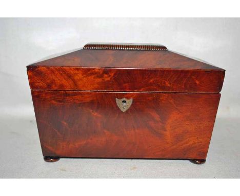 A 19th century mahogany Tea Caddy of sarcophagus shape on shallow bun feet, hinged lid enclosing a pair of lidded compartment