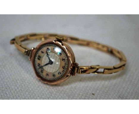 A 9ct gold ladies Wrist Watch with mother of pearl chapter ring on a 9ct gold expanding strap, case marked Chester 1868, 18g 