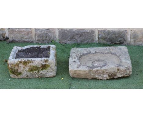 A SANDSTONE TROUGH of shallow oblong form, 24" x 17" x 6 1/2", together with another, well cut, 18" x 14 3/4" x 8" (2) (Est. 
