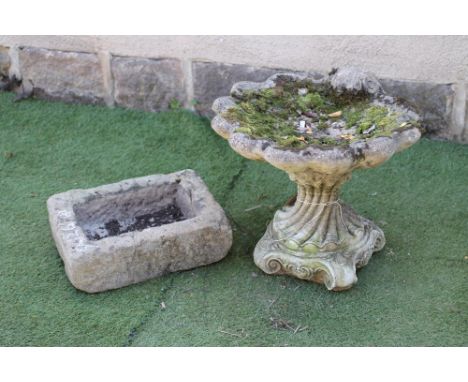 A COMPOSITION STONE BIRD BATH, modelled as a scallop shell, on wrythen fluted socle and scrolled feet, 20 1/2" x 19" x 18 1/2