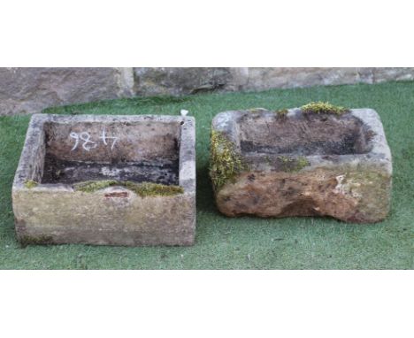 A SMALL SANDSTONE TROUGH of rough hewn oblong form, 18 1/2" x 12 1/2" x 8", together with another similar in composition ston