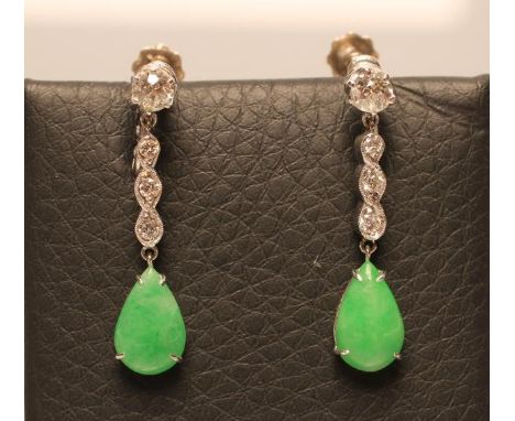 A PAIR OF ART DECO DROP EARRINGS, the tear polished jade panels claw set and pendant from a rope twist drop set with three sm