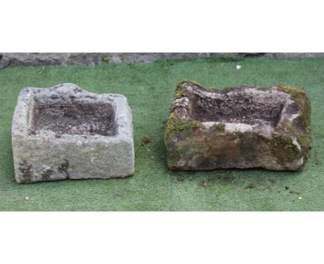 A SMALL SANDSTONE TROUGH of rough hewn oblong form, 23 1/2" x 14 1/2" x 7 1/2", together with another, 18 1/2" x 15" x 9" (2)