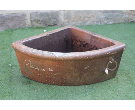 A SALTGLAZE STONEWARE QUADRANT TROUGH with moulded rim and applied with a metal ring, 25" x 13 1/2" (Est. plus 21% premium in