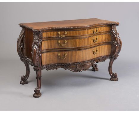 A LOUIS XV STYLE COMMODE, 20th century, of serpentine outline and comprising three graduated drawers with foliate gilt metal 