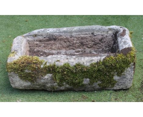 A SANDSTONE TROUGH of rough hewn oblong form, 15" x 29" x 7 1/2" (Est. plus 21% premium inc. VAT)