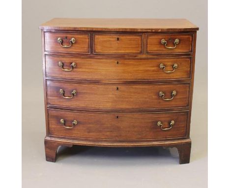 A GEORGIAN MAHOGANY CHEST, early 19th century, of bowed form with stringing, moulded edged top over three small frieze drawer