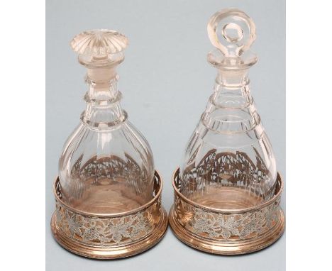 A PAIR OF PLATED ON COPPER BOTTLE COASTERS of plain cylindrical form, pierced and engraved with fruiting vine, the polished a