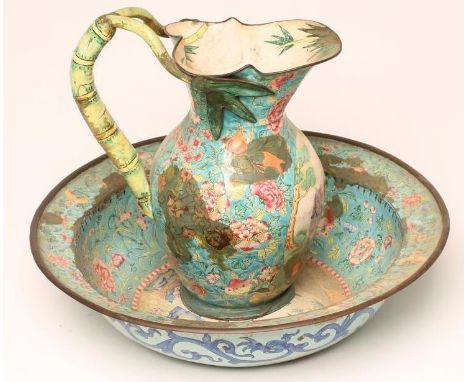 A CANTON ENAMEL TOILET JUG AND BASIN, the baluster jug painted in colours with a panel of two figures and a horse in landscap