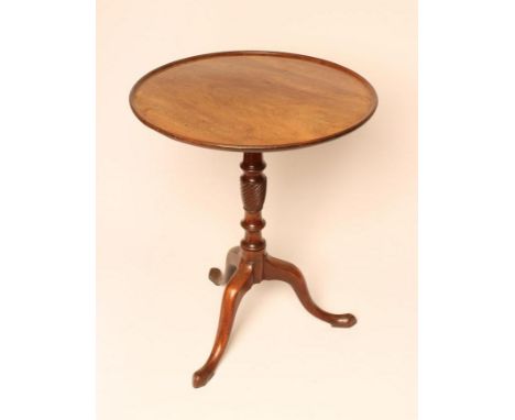 A GEORGIAN MAHOGANY TRIPOD TABLE, c.1800, the dished circular hinged top on a ring and part wrythen turned vase stem, down cu