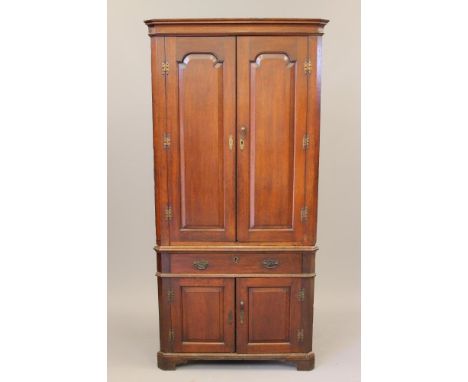 A GEORGIAN OAK STANDING CORNER CUPBOARD, mid/late 18th century, the cavetto moulded cornice over a pair of arched fielded doo