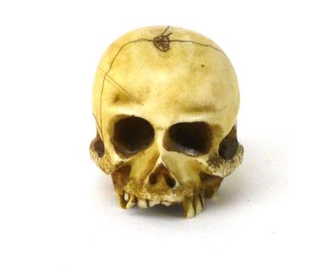 A Japanese ivory netsuke carved in the form of skull apparently unsigned 3.5cm long  CONDITION REPORT: some teeth broken, oth