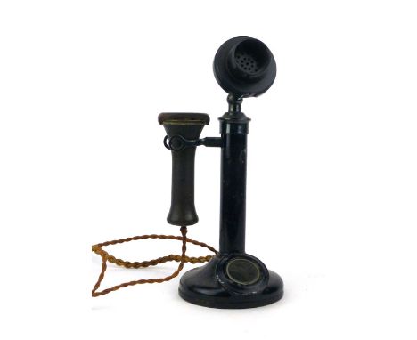 A black lacquered candle stick telephone with Bakelite mouth and ear piece h. 32cm CONDITION REPORT: No warranty offered as t