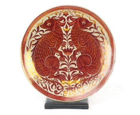 A William De Morgan red lustre charger decorated with a pair of mythical rabbit like beasts on a scrolling floral ground, the